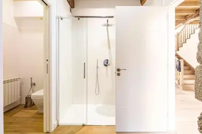 a bathroom with a shower with a glass door at Casa Taboada in San Román