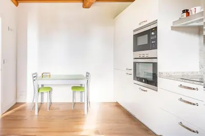 a kitchen with a small table and a microwave at Casa Taboada in San Román