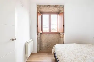a bedroom with a bed and a window at Casa Taboada in San Román
