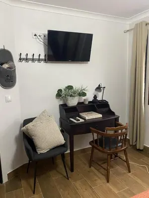 a living room with a desk and a window at Os Fentos in Pontevedra