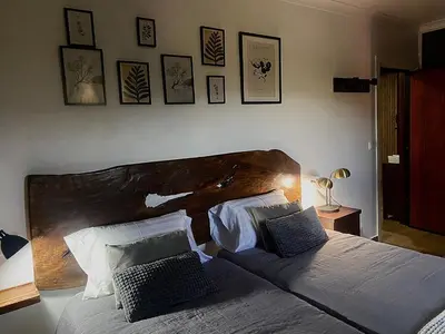 a bedroom with two beds and a ceiling at Os Fentos in Pontevedra
