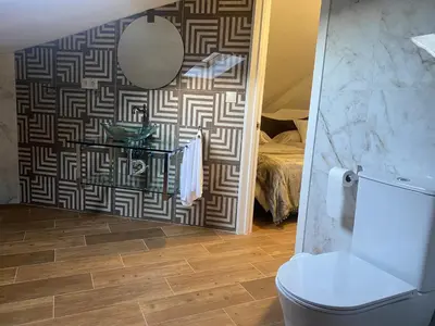 a bedroom with two beds and a television on the wall at Os Fentos in Pontevedra