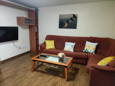 a living room with a brown couch and a coffee table at Val de Lemos in Monforte de Lemos
