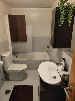 a bathroom with a white toilet and a sink at Val de Lemos in Monforte de Lemos