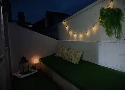 a bench with a pillow on a wall with lights at Val de Lemos in Monforte de Lemos