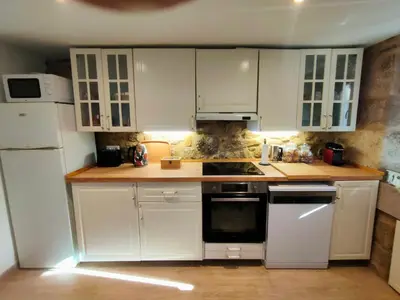 a kitchen with white cabinets and white appliances at O Rincón de Esther in Vedra