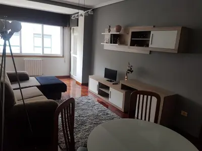 a living room with a couch and a table at El Descanso de Ana in Ourense