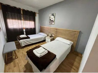 a room with two beds in a room at Pension Matias Rooms in Sarria