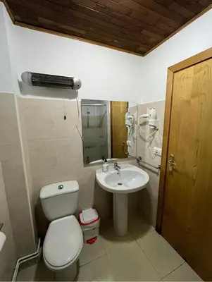 a bathroom with a toilet and a sink at Pension Matias Rooms in Sarria