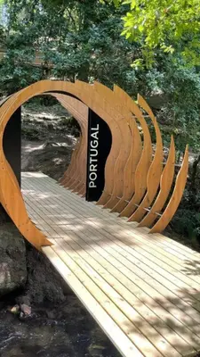 a wooden bridge over a stream in a park at Sola Costeiro in Padrenda
