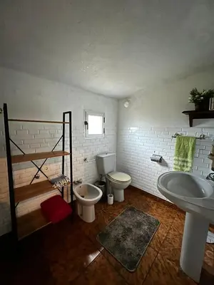 a bathroom with a sink and a toilet and a tub at Sola Costeiro in Padrenda