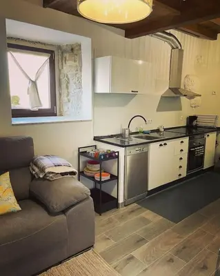 a small kitchen with a couch in a room at Casa Vilar (Taboadela-Ourense) in Taboadela