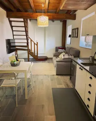 a kitchen and living room with a table and a couch at Casa Vilar (Taboadela-Ourense) in Taboadela