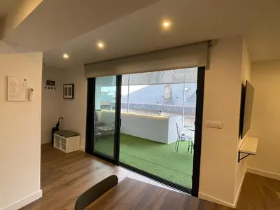 a room with a sliding glass door with a view of a patio at C&G Ático Céntrico con Terraza in Ourense