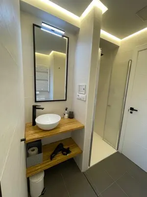 a bathroom with a sink and a mirror at C&G Ático Céntrico con Terraza in Ourense