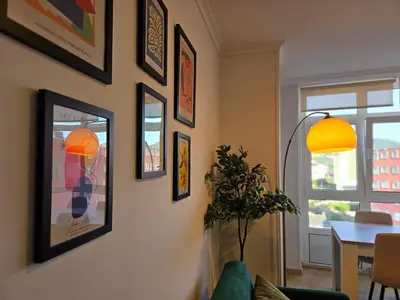 a living room with framed pictures on the wall at Los Castelos by Urraca Suites Viveiro in Viveiro