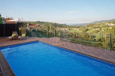 a swimming pool in a yard with a fence at Casa Del Ingles - Luxury Private Villa & Pool in Rural Valley in Pontevedra