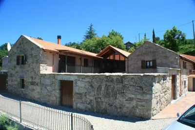 a stone house with a fence in front of it at Casa Del Ingles - Luxury Private Villa & Pool in Rural Valley in Pontevedra