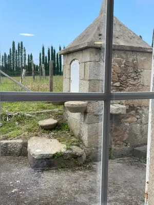 a view of a stone building from a window at A casa de Lago in Lago
