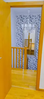 a view of a room with a mirror and a staircase at Apartamento Buen Camino in O Pedrouzo