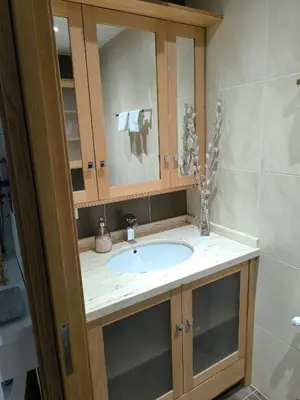 a bathroom with a sink and a cabinet at Apartamento Buen Camino in O Pedrouzo