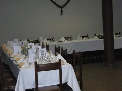 a row of tables with white table cloths on them at Hostal la Cuesta in Vega de Espinareda