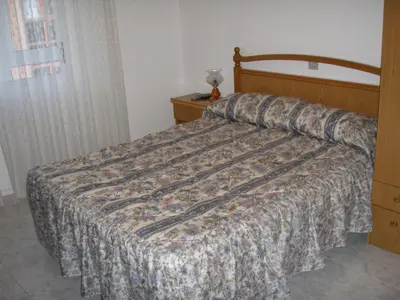 a bedroom with a bed with a comforter on it at Hostal la Cuesta in Vega de Espinareda