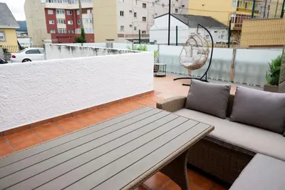 a balcony with a chair and a swing at Chalet frente a Rapadoira.Foz in Foz