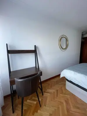 a bedroom with a desk and a bed and a chair at Appartement vistahermosa in Vivero