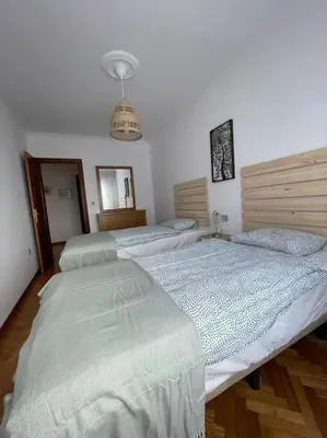 a bedroom with three beds in a room at Appartement vistahermosa in Vivero