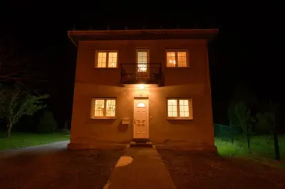 a house with a light on the door at night at Casa Manuel in Vivero