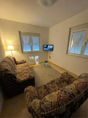 a living room with two couches and a tv at Casa Manuel in Vivero