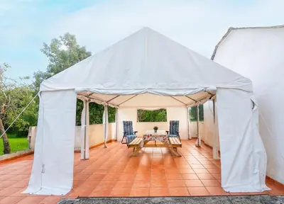 a tent with a table and chairs on a patio at Casa Manuel in Vivero