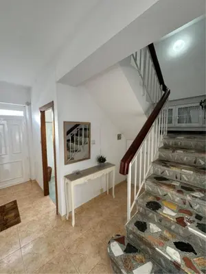 a room with a staircase with a table and a stair case at Casa Manuel in Vivero