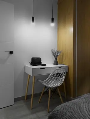 a desk with a chair next to a wall at El Rincón de la estación in Ourense