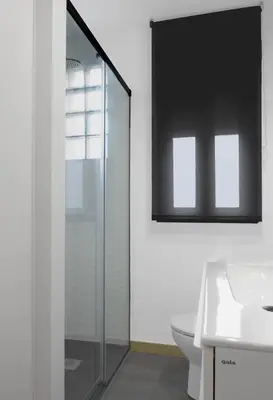 a bathroom with a glass shower and a sink at El Rincón de la estación in Ourense