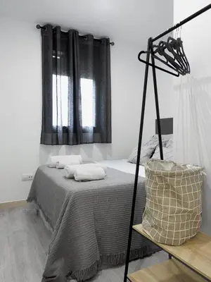 a bedroom with a bed and a window at El Rincón de la estación in Ourense