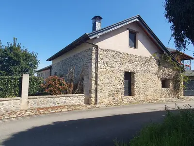 a stone house on the side of a road at Casa Rural El Bierzo Oro en el Camino in Villaverde de la Abadía