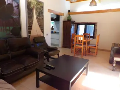 a living room with a couch and a coffee table at Casa Rural El Bierzo Oro en el Camino in Villaverde de la Abadía