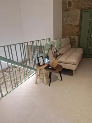 a living room with a couch and a table at A casa d'abaixo in Parada del Sil