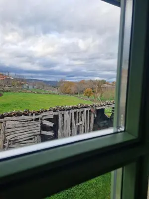 a view of a field from a window at A casa d'abaixo in Parada del Sil