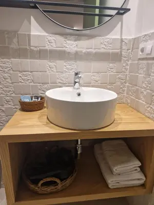 a bathroom with a white sink and a mirror at A casa d'abaixo in Parada del Sil
