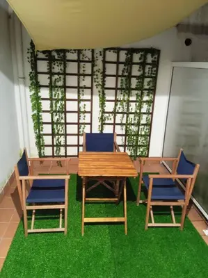 a table and two chairs and a wooden table and chairs at O Picho: apartamento céntrico. in Puentedeume