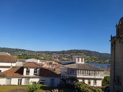 a group of houses in a town with a lake at O Picho: apartamento céntrico. in Puentedeume