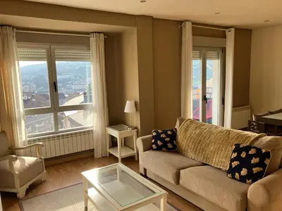 a living room with a couch and a table at Vivienda estación in Ourense