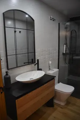 a bathroom with a sink and a toilet at Casa Sapita in Villafranca del Bierzo