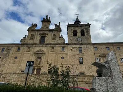 a large stone building with a clock tower on it at Casa Sapita in Villafranca del Bierzo