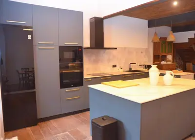 a kitchen with a white counter top in a room at Casa Sapita in Villafranca del Bierzo