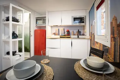 a kitchen with a table with bowls and plates on it at Riquiña Celanova in Celanova