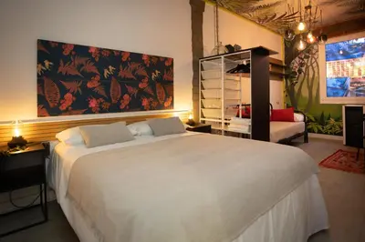 a bedroom with a large white bed and a couch at Riquiña Celanova in Celanova